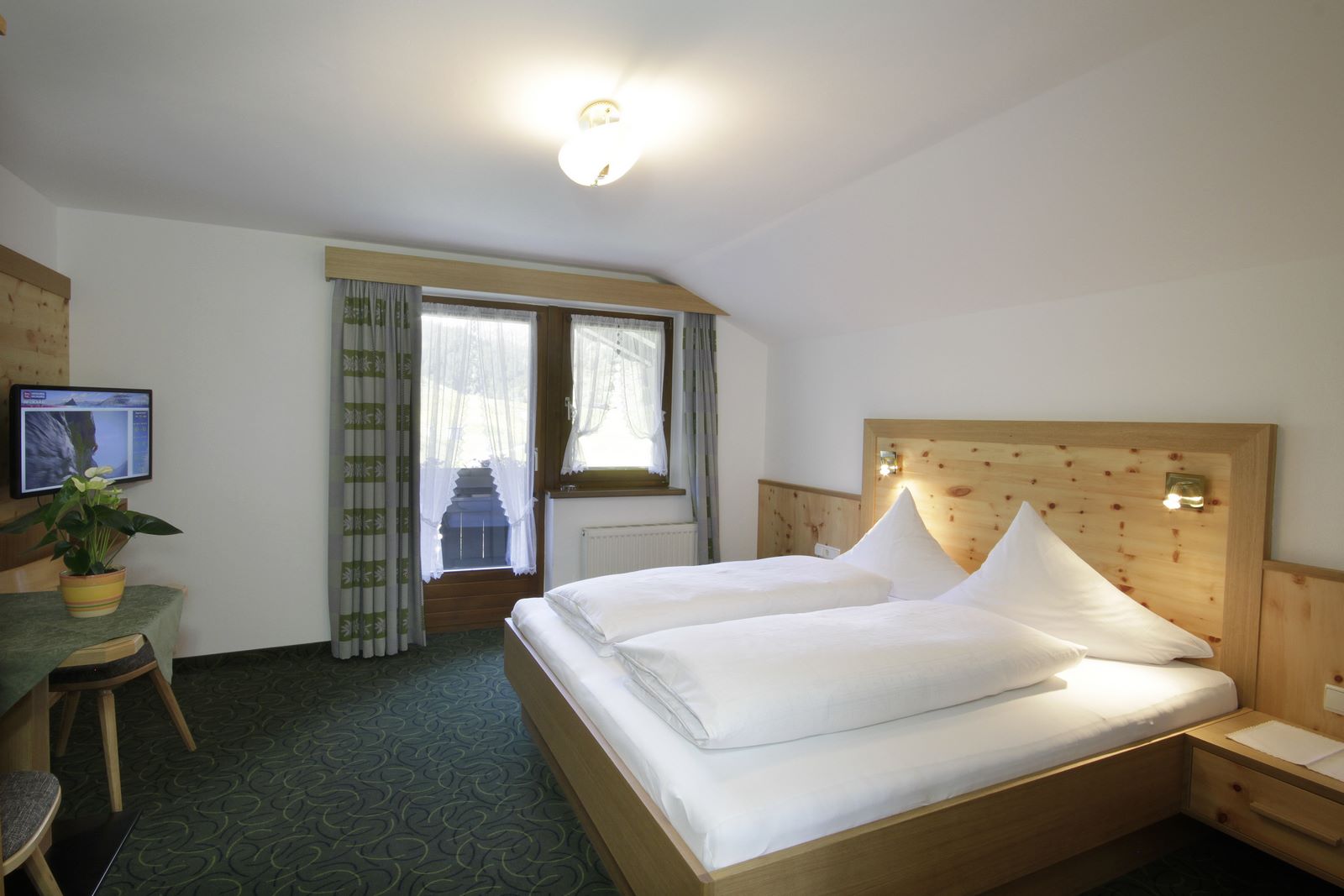 Doublebed with Dining area and TV in one of our double rooms